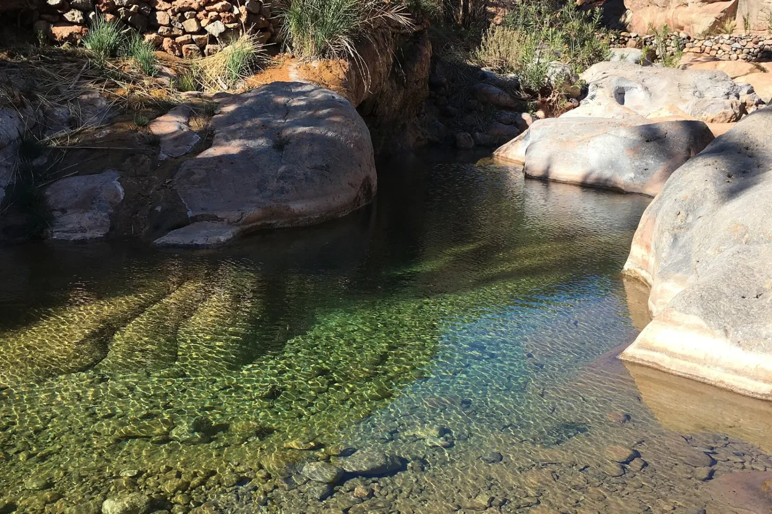 Turquoise natural pool between rocks in Paradise Valley