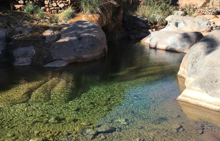 Turquoise natural pool between rocks in Paradise Valley