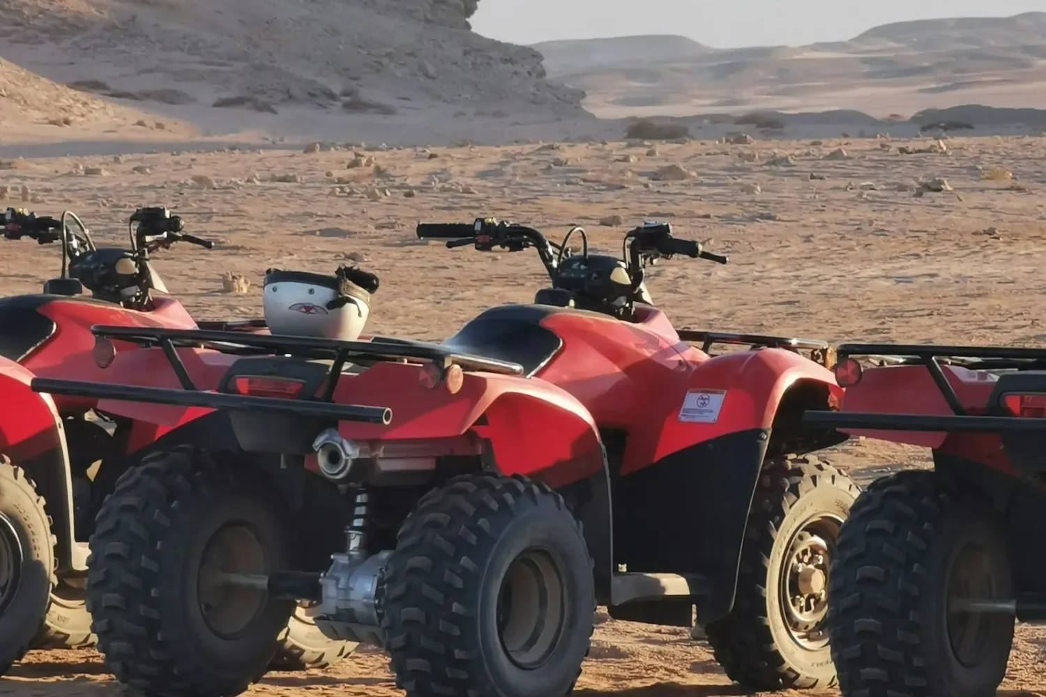 Quad bikes parked on the sand