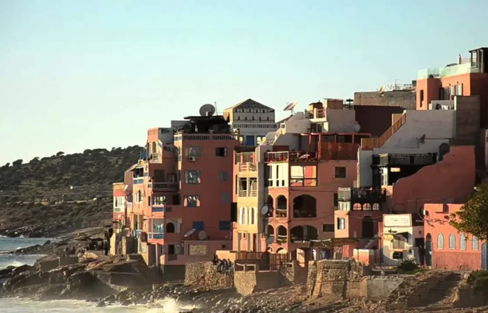 Painted houses of Taghazout village above the sea